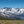 Snow-covered Sierra Nevada peaks and a deep blue alpine lake seen from a high ridge during the Coyote Flats overland trip, September 4–7, 2026.