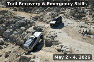 A black off-road vehicle uses a recovery line to safely assist a silver SUV stuck on steep rocky terrain during the Weekend Off Road Trail Recovery & Emergency Skills event in May 2026.