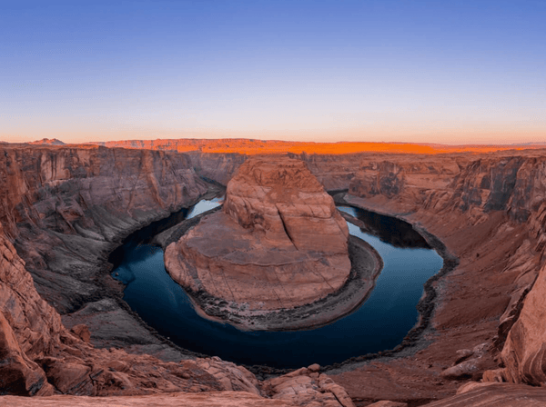 Horseshoe Bend at sunset with canyon walls and river curves featured during the Lake and Canyon Relaxation 2026 trip.