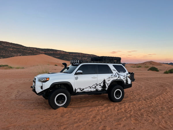 Toyota 4Runner parked on desert sand at sunset during the Lake and Canyon Relaxation 2026 trip.