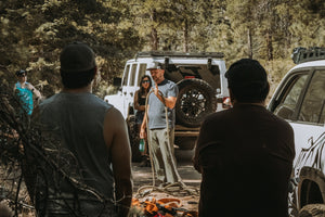 Instructor teaching off-road recovery techniques using a kinetic rope during a Weekend Offroad training session in the forest.